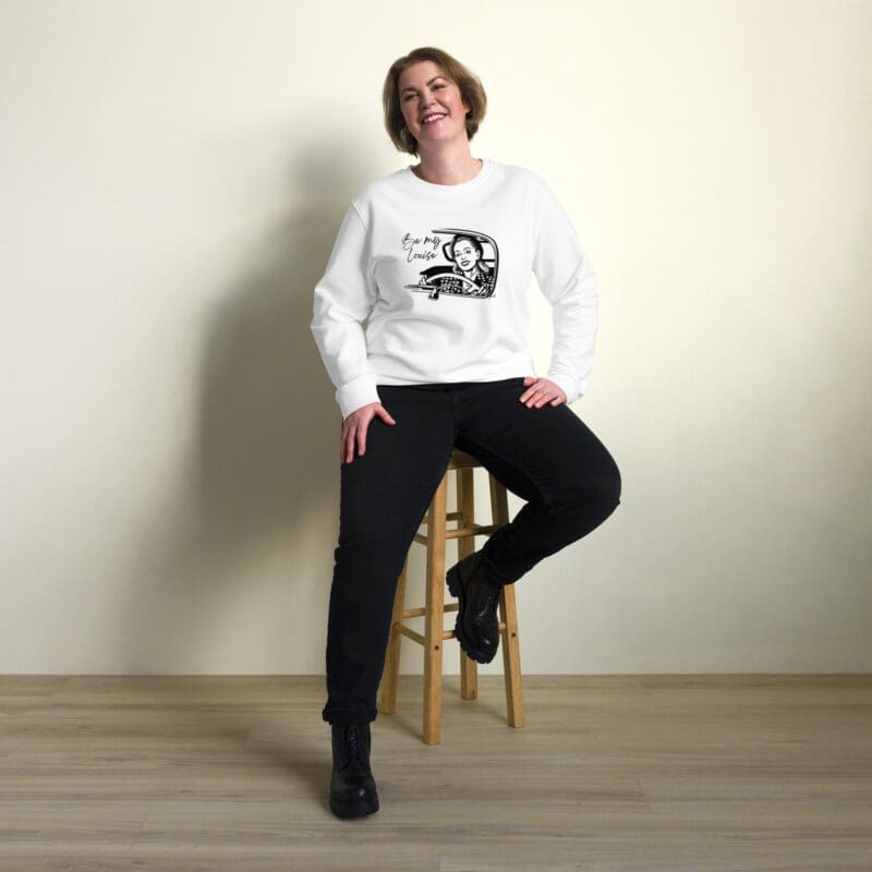 woman sitting on with white sweatshirt graphic of a retro woman driving text reads The Be My Louise Organic Sweatshirt